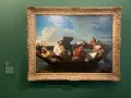 Gustave Courbet dépeint des voyageurs sur une barque, sous un ciel nuageux. L'un d'eux semble endormi, tandis que les autres conversent.
