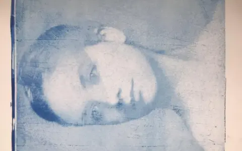 Portrait d'une personne en gros plan, réalisé par transfert photo sur gelli plate. L'image est en tons bleus, avec des textures et des lignes visibles.