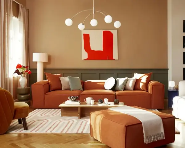 Salon cosy avec canapé orange, fauteuil velours et un tableau couleur chaude.