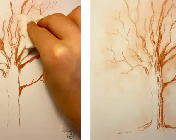 Main gauche estompant un dessin de sanguine d'un arbre nu, créant un effet doux. Un dessin sanguine facile pour un rendu artistique.