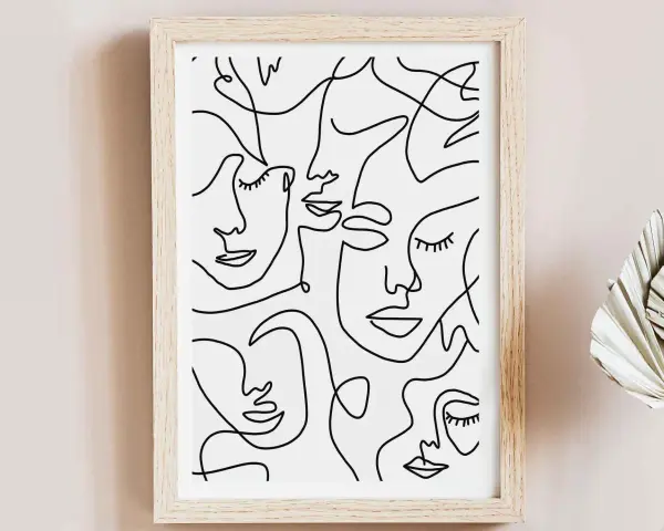 Tableau abstrait visage, une composition de visages stylisés en lignes continues noires sur fond blanc, dans un cadre en bois clair.
