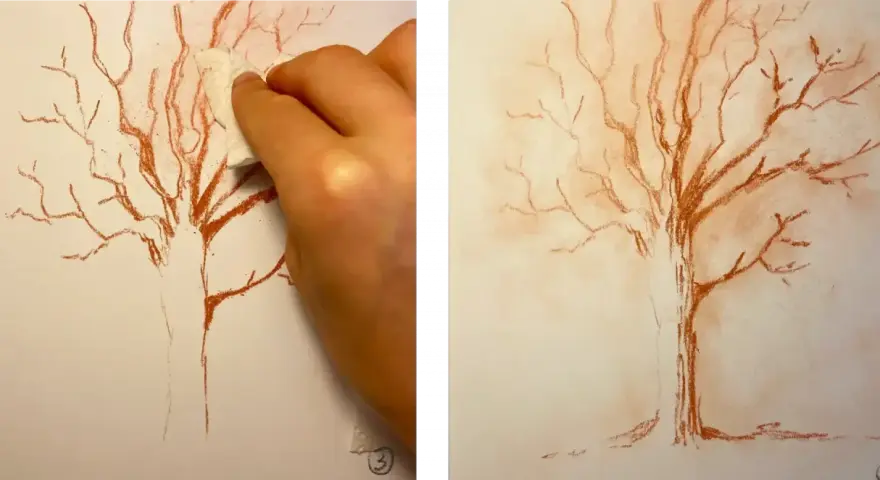 Main gauche estompant un dessin de sanguine d'un arbre nu, créant un effet doux. Un dessin sanguine facile pour un rendu artistique.