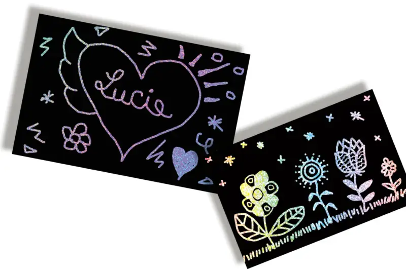 Un cœur ailé avec le nom "Lucie" et des fleurs colorées sur fond noir. Un **modèle dessin à gratter facile** pour s'amuser.